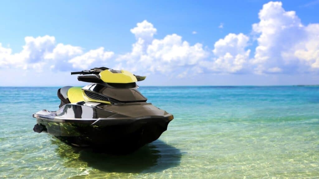A yellow jet ski parked on a beach on Maui