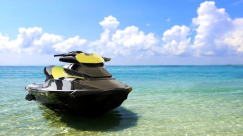 A yellow jet ski parked on a beach on Maui