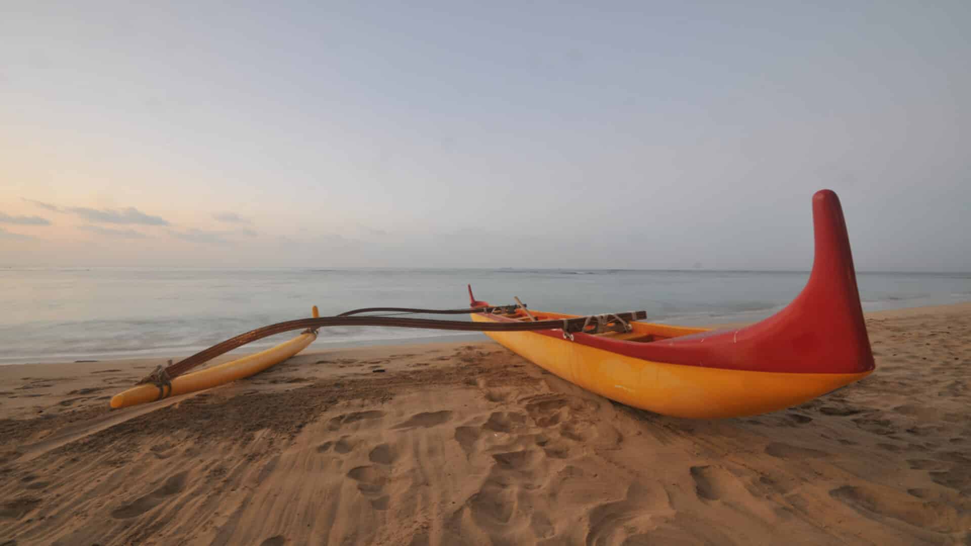 An outrigger canoe on a beach in Maui