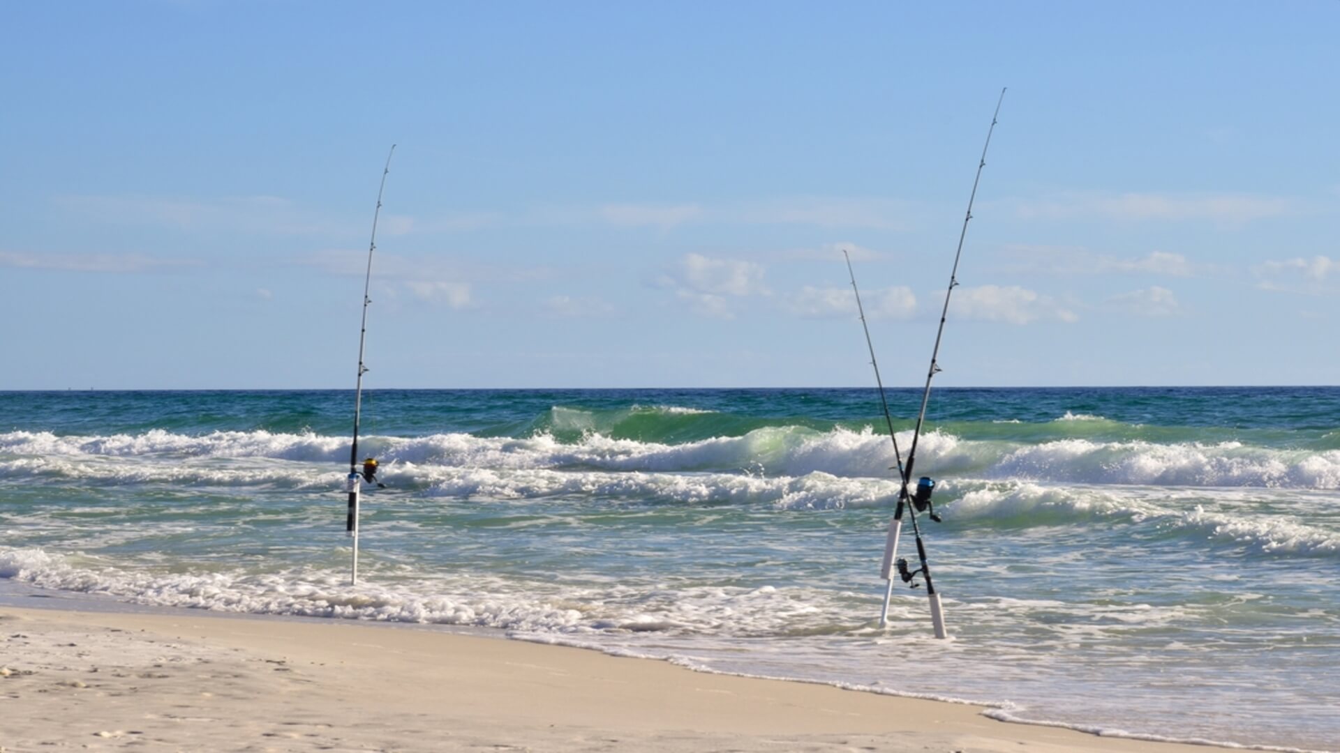 Two fishing poles on a beach in Maui