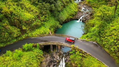 A car driving on Maui's famous Road to Hana when it rains