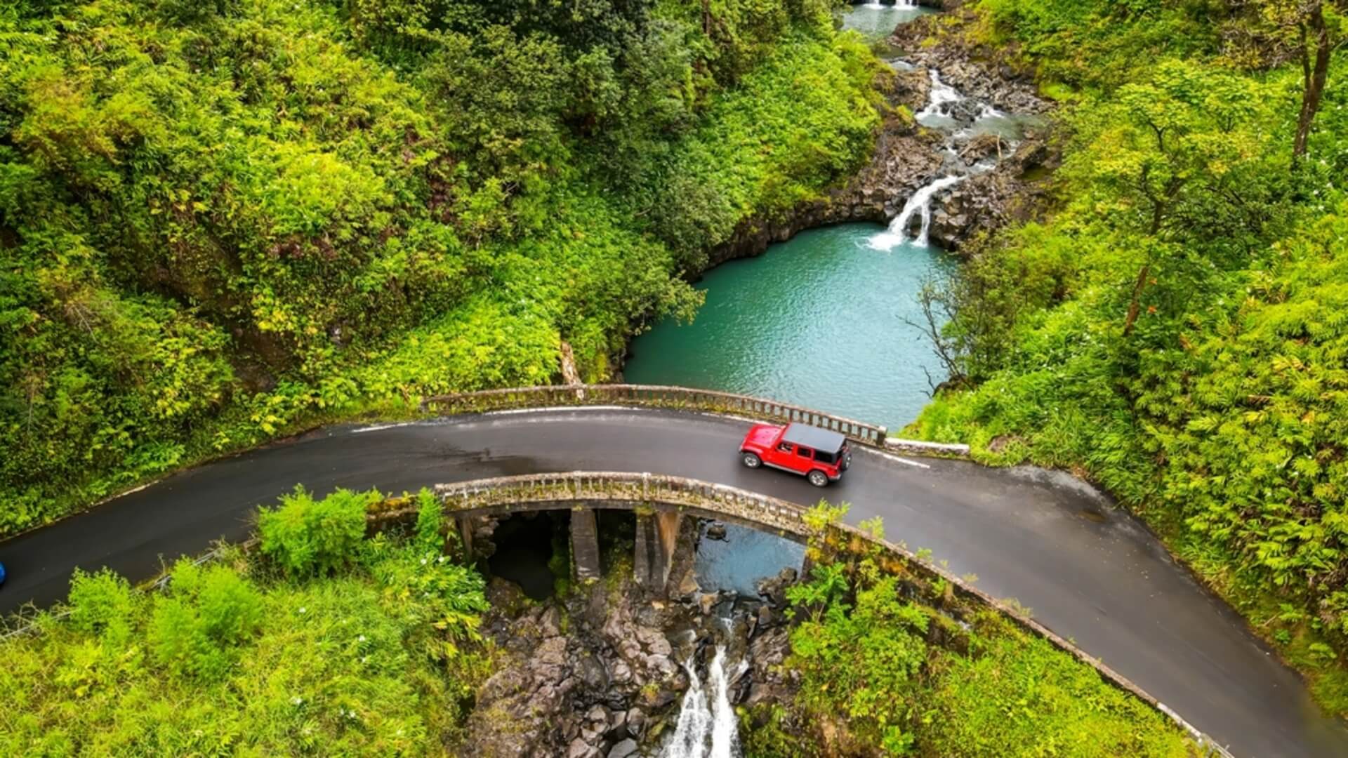 A car driving on Maui's famous Road to Hana when it rains