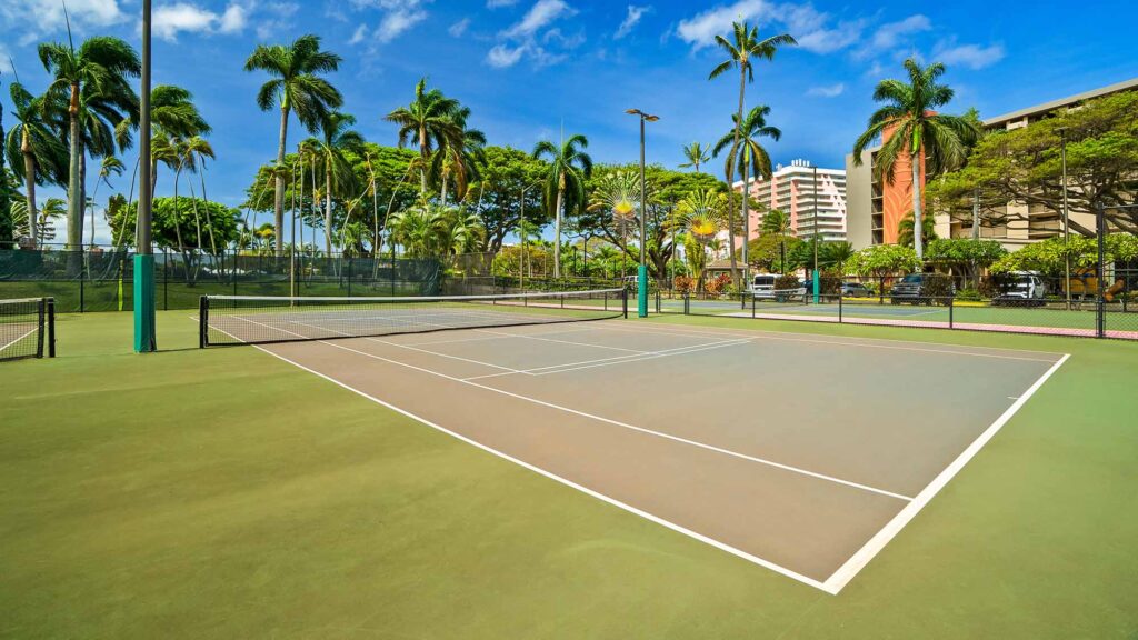 The tennis and pickleball courts surrounded by palm trees, one of the many activities available to guests at Kaanapali Shores