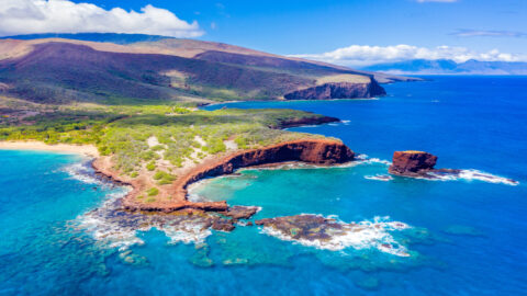An aerial shot of Lanai and its rugged coast and crystal clear waters taken during a day trip from Maui