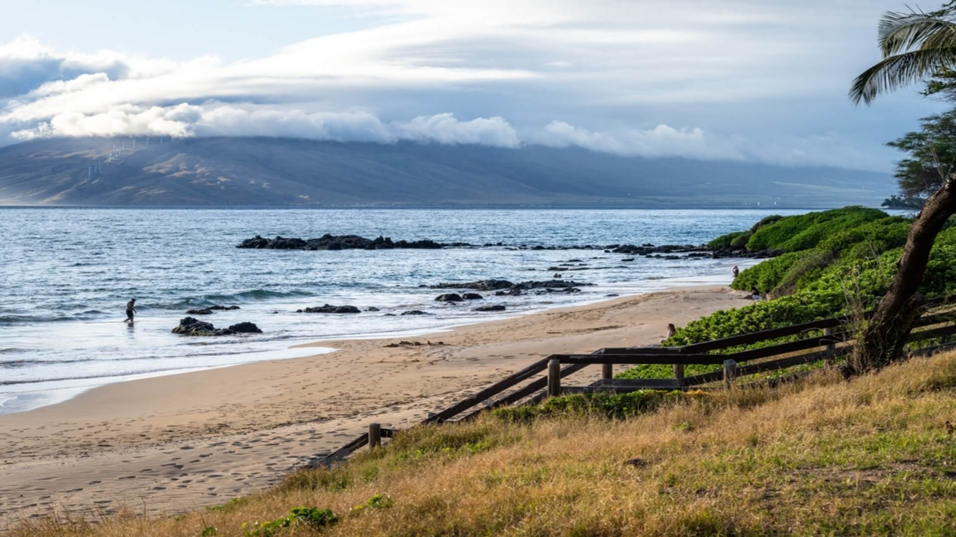 The beach at Kamaole Beach III overlooking Lanai and the grassy beach park above